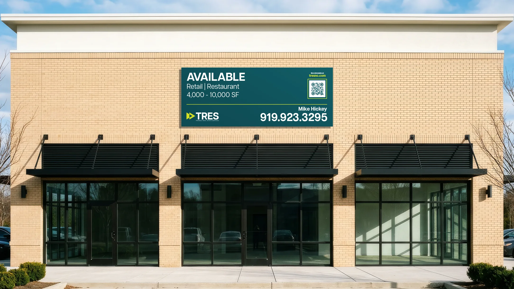 TRES leasing banner on a brick retail building, advertising available retail and restaurant space from 4,000 to 10,000 square feet